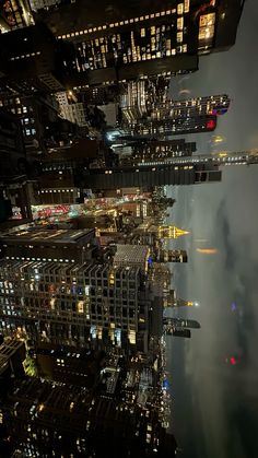 an aerial view of the city lights and skyscrapers in new york city at night