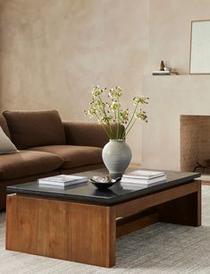 a living room with a couch, coffee table and fireplace