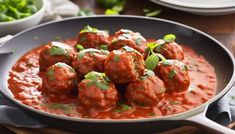 meatballs covered in tomato sauce and garnished with parsley