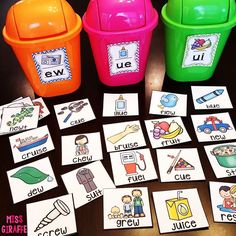 four buckets filled with different pictures on top of a table