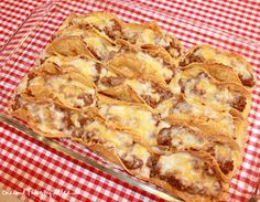 a table topped with a pizza covered in cheese