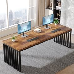 a computer desk with two monitors and keyboard on it in front of a large window