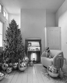 a living room filled with silver ornaments and a christmas tree