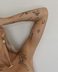 a woman with tattoos on her arm and chest