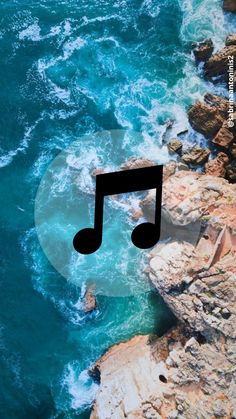 an aerial view of the ocean with a musical note in the foreground and waves crashing on the rocks