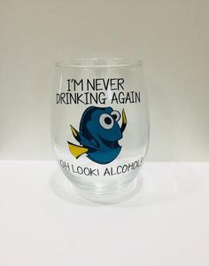 a shot glass with the words i'm never drinking again and an image of a blue fish