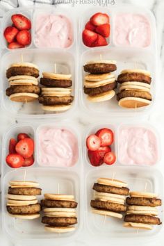 several trays filled with food and strawberries on top of each other in plastic containers