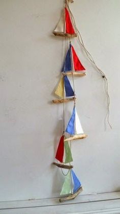 a group of sailboats hanging on a wall