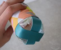 a hand is holding an object made out of duct tape