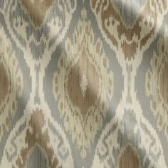 an upholstered fabric with brown and beige designs