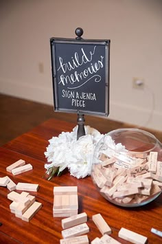 a table topped with lots of wine corks next to a chalkboard sign that says build your own