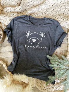 ✧ ITEM DESCRIPTION ✧ This set includes One *Grey* Mama Bear T-Shirt (select size) -With an option for- One *Cream* Little Bear Bodysuit- OR White T- Shirt ✧Size ✧ Adult Shirt sizing is Unisex Sizing S *CHEST* 18 in *LENGTH* 28 in M *CHEST* 20 in *LENGTH* 29 in L *CHEST* 22 in *LENGTH* 30 in Wash * Cold water inside out *All my items are handmade so each piece is unique for you! *Made in my smoke free home I hope you enjoy my products as much as I do! But please note that the product designs in t Gray Cotton T-shirt With Cartoon Print, Casual White T-shirt With Bear Design, Cotton Tops With Bear Print And Relaxed Fit, Gray Cotton Top With Cartoon Print, Cute Cotton T-shirt With Bear Design, Cute Short Sleeve Tops With Bear Print, Cute Short Sleeve Top With Bear Print, Cute Bear Print Short Sleeve Tops, Cute Bear Print Top With Short Sleeves