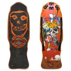 two old skateboards with different designs on them