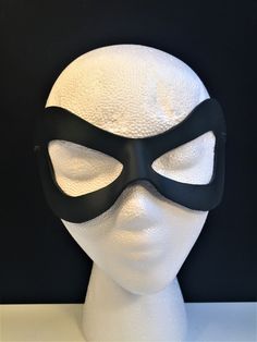 DESCRIPTIONAdd spice to your love life! This small, very lightweight, black leather mask is perfect for the beginner dominatrix or Lord of the Bedroom. Any color. Silver studs available. Waterproofed leather, glossy or matte finish, & several choices to affix the mask (cord, elastic, ribbon, waterproof cord, stick, or no holes for adhesive). Measurements: 3" high x 7" wide (tallest & widest points); 1" high between the eyes; 2.75" wide x 2.75" tall eye openings ---------------------------------- Lone Ranger Costume, Splatoon Costume, Mask Cord, Robin Superhero, Comicon Costume, Ranger Costume, Robin Cosplay, Black Wear, Superhero Masks