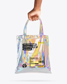 a hand holding a holographic shopping bag mockup