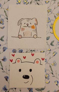 two cards with drawings of dogs and flowers on them, one has a flower in its mouth