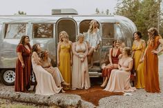 a group of women standing next to each other in front of a silver airstream