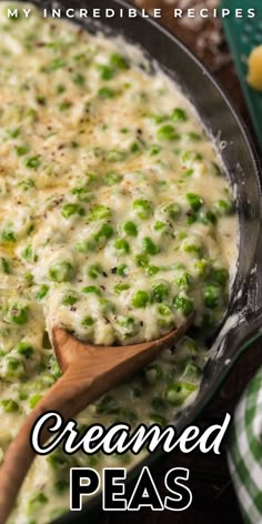 a casserole dish with peas in it and a wooden spoon on the side