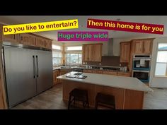 an empty kitchen with stainless steel appliances and wooden cabinets, is shown in this image