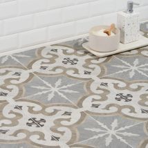 a bath room with a toilet and a bowl on the floor in front of a tiled wall