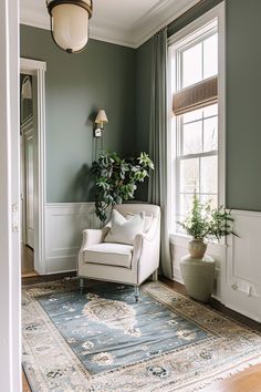 a living room filled with furniture and a rug on top of a hard wood floor