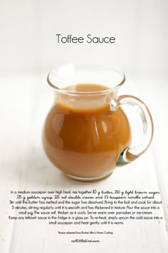 a glass pitcher filled with liquid sitting on top of a white countertop next to an advertisement