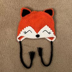 a knitted hat with a fox design on it