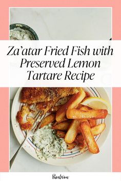 a white plate topped with fried fish and french fries