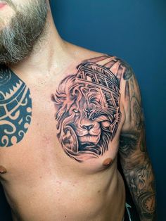 a man's chest with a lion tattoo on it and an ornamental design around his neck