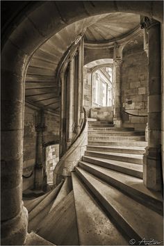 an old building with stairs leading up to the door and window in the center, black and white photograph