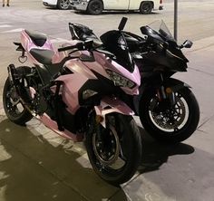 two motorcycles are parked on the side of the road