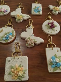 several ceramic key chains with flowers and hearts on them