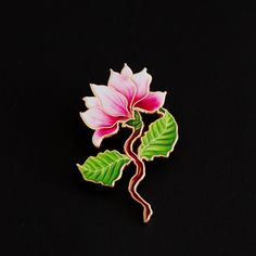 Quick Overview: Size: 1.75" Tall Theme: Floral - Magnolia Color: Soft Pink and White Material: Premium Quality Enamel. Utilizes UV printing, a technique that allows us to capture more intricate details compared to traditional enamel methods. Description: Step into a world of elegance with the "Magnolia (Pink) Enamel Pin." This beautifully crafted pin, standing at 1.75" tall, showcases the delicate beauty of a magnolia flower in a soft, serene shade of pink. The pin is made from premium quality enamel, ensuring a lustrous finish that brings the gentle essence of the magnolia to life. Symbolism: The magnolia flower, known for its grace and ancient beauty, symbolizes dignity, nobility, and a love of nature. Wearing this pin is not only a fashion statement but also a reflection of these timele Plant Enamel Pin, Magnolia Colors, Pink Magnolia, Enamel Pin Collection, Magnolia Blossom, Floral Pins, Ancient Beauty, Small Pin, Magnolia Flower