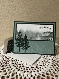 a card with trees on it sitting on top of a table