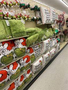 the shelves are filled with christmas pillows and other holiday decorations at a walgreen store