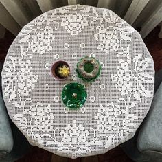 a white table topped with two bowls filled with fruit