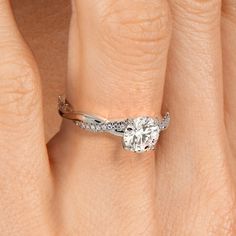 a woman's hand with a yellow gold ring and diamond set in the middle