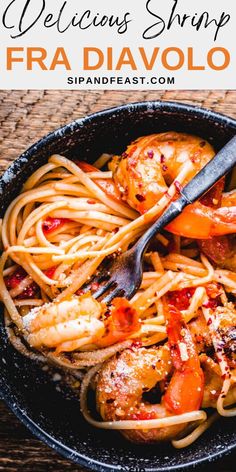 pasta with shrimp and tomato sauce in a skillet on top of a wooden table