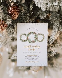 a white and gold christmas party with pineconi wreaths on the front card