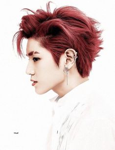 a person with red hair and piercings on their ears