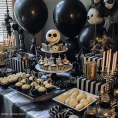 a table topped with black and white desserts