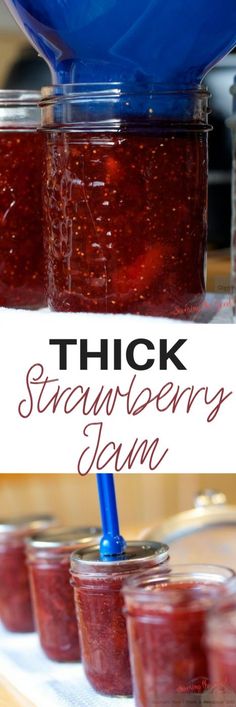 jars filled with strawberry jam sitting on top of a table