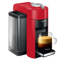 a red coffee maker next to a cup of coffee