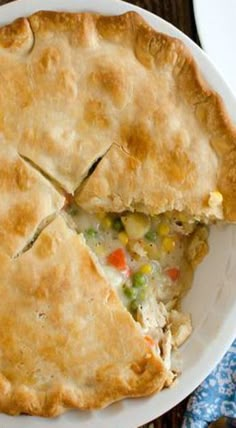 a white plate topped with a pie on top of a wooden table