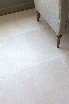 a couch sitting on top of a white tile floor