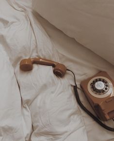 an old phone is laying on the bed