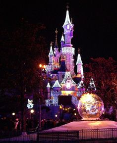 the castle is lit up with christmas lights