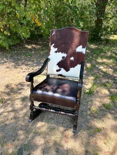 an old chair with cow hide upholstered on it