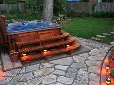 a hot tub sitting on top of a stone patio