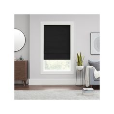 a living room with white walls and black blinds